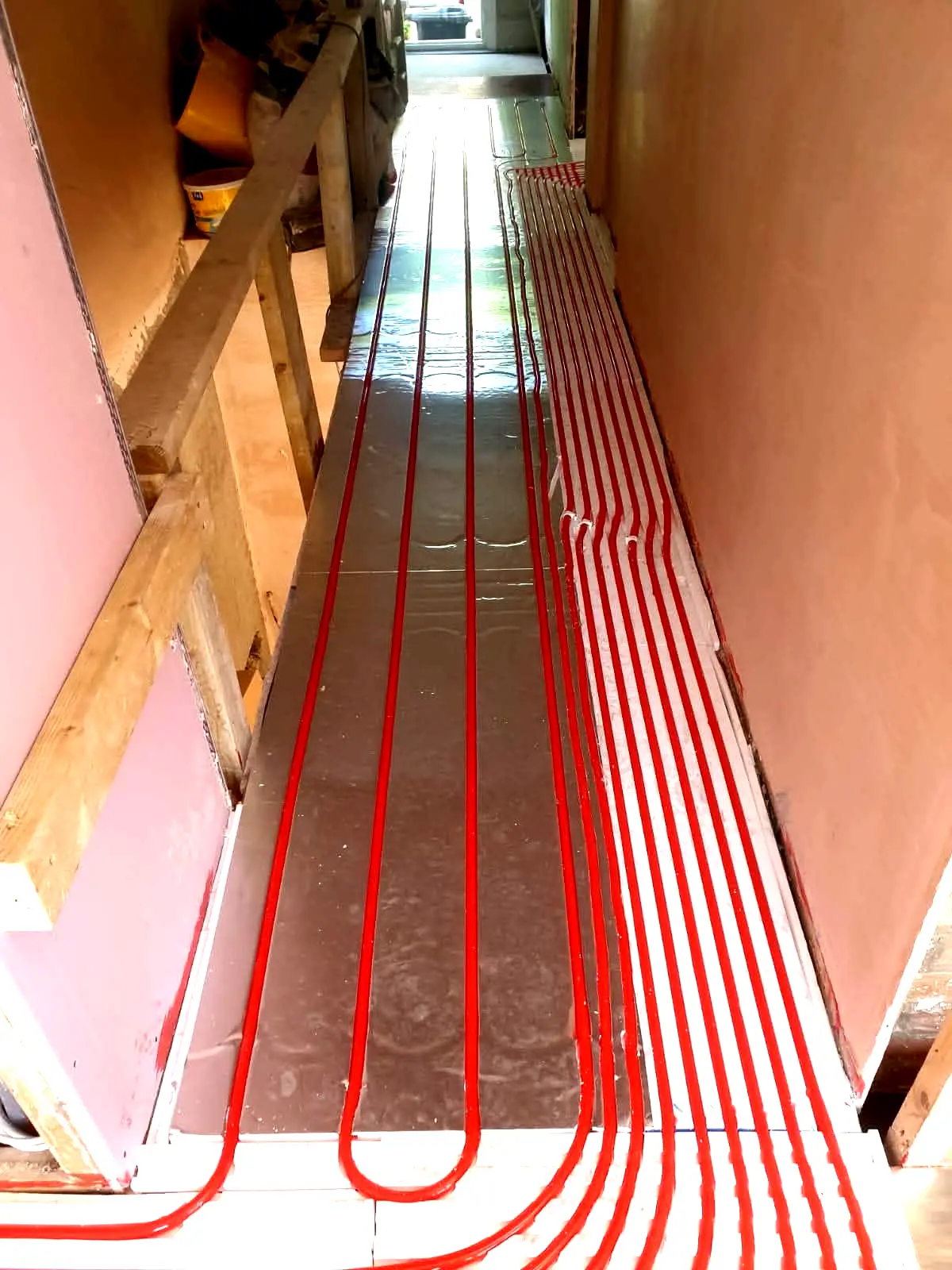 Completed wet underfloor heating pipe grid on foil insulation prior to screeding in a new build house, Bristol