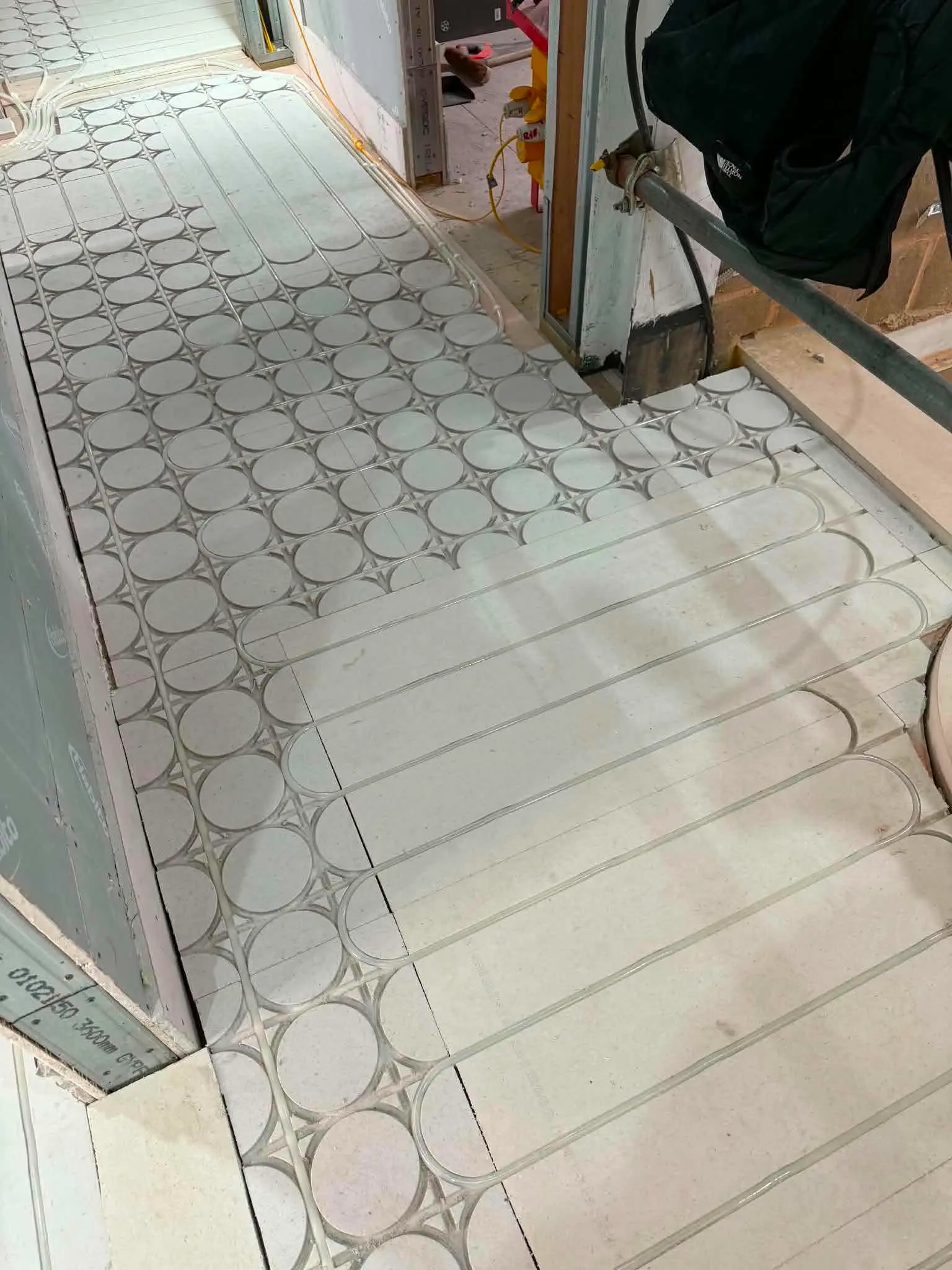 Room interior showing castellated floor insulation boards prepared for wet underfloor heating at The Kensington Crown Penthouse