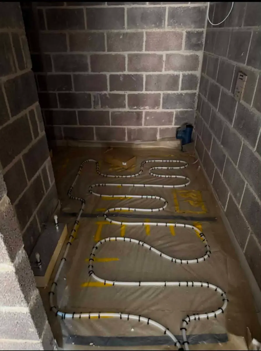 Dense loop layout of PEX underfloor heating pipes on insulation in a smaller room, Oakwood Residence, Reading